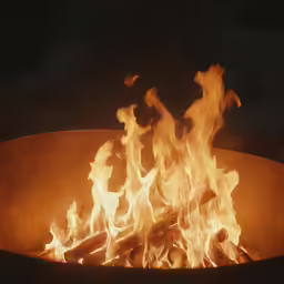 a fire pit with many logs and some glowing