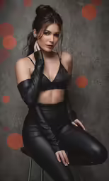 a woman sitting in a black top and pants