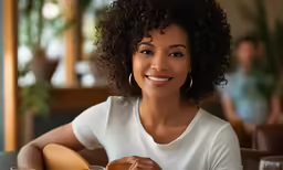 a beautiful woman sitting at a table with pizza