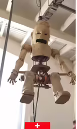 a robot like figure hanging from a ceiling