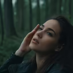 the woman is holding her head near her eyes