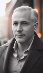 black and white photo of man wearing suit with greying hair