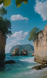 a view of a beach with a rock formation in the background