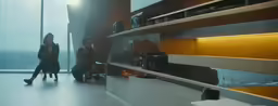 two women are standing in a darkened room with their luggage