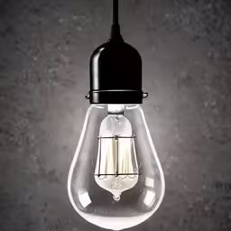 an old light hanging in a dark room