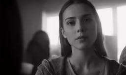 a girl standing in the middle of a room looking at something