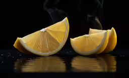 smoke billows from one slice of lemon as it is half closed