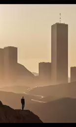 a person is standing on a hill in front of buildings