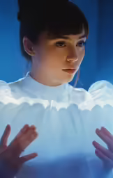 a woman is in white with her hands on the back of the shirt