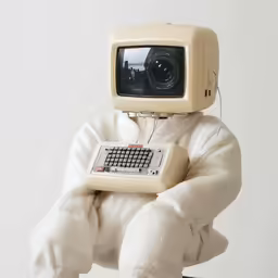 an old computer man is sitting on a stool