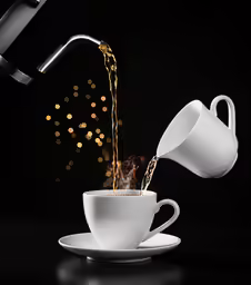 a coffee mug with water being poured into it