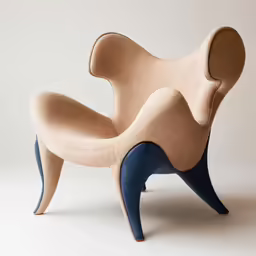 a chair made out of clay and leather with an open backrest
