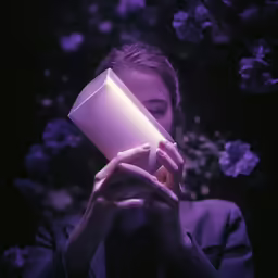 a woman holding a cup in her hands