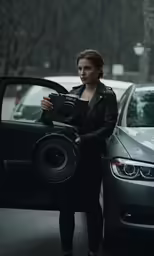a lady taking a photo next to her car