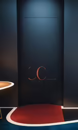 a black room with a red carpet and wall