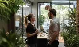 a woman and man in a office talking