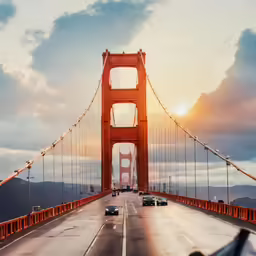 traffic goes through the golden gate bridge at sunrise