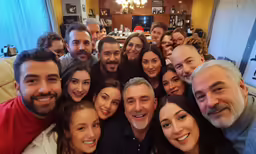 a group of people smiling and posing for a picture