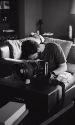 a person sitting on a couch with a camera