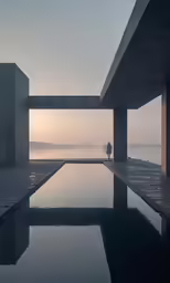 a man is standing in a pool near two buildings