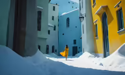 woman walking through a snowy alley way surrounded by tall buildings