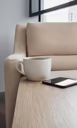 a smartphone is on a table near a bowl