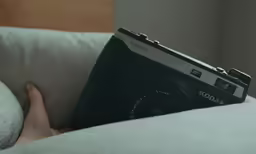 the camera is sitting on the back of a couch
