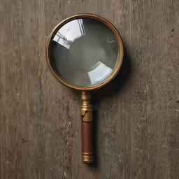 a magnifying glass sitting on top of a wooden table