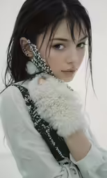 an asian girl in white shirt holding white fur