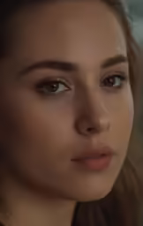 a close up shot of the face of a young woman