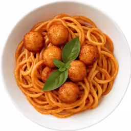 an overhead view of spaghetti and meatballs with fresh basil