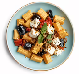a blue plate with a vegetable salad and tofu on top