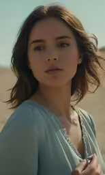 a close up of a person wearing a dress and holding a shirt