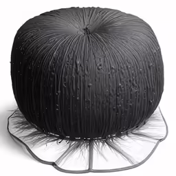 black tulle covered cushion on a white background
