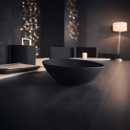a modern living area has a table with books, notebook and large bowl on it