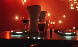 several glasses and a wine bottle are on a table