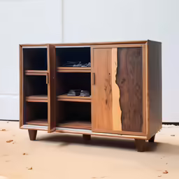 this wood cabinet has drawers and compartments that have been carved