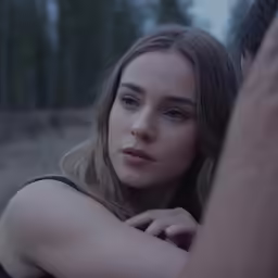a beautiful young lady holding her arms around herself