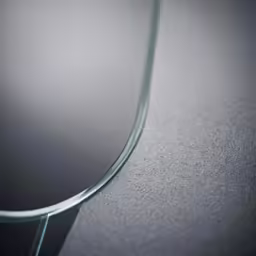 a shiny metallic surface with very long curved mirrors