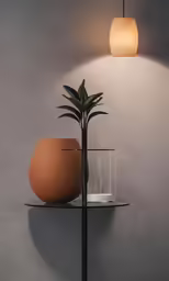 an orange pot and vase on a shelf