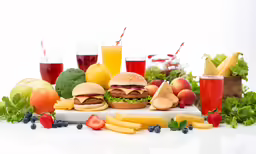 many types of foods and drinks are arranged on a white surface