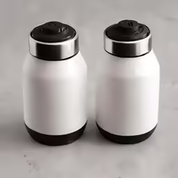 two salt and pepper shakers are sitting on the counter