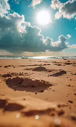 a photo of the ocean with a lot of sand and clouds