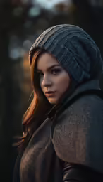 a woman standing in the dark with a grey coat