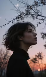 a young woman is gazing into the distance