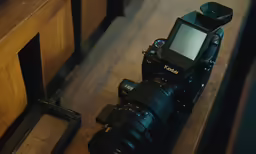 a camera with a white screen sitting on top of a table