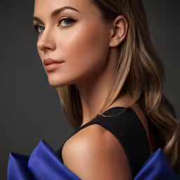 a woman with blue eyes and long hair wearing a dress