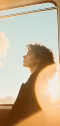 woman looking out a window in a vehicle