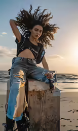 a girl with dreadlocks is sitting on a cement post