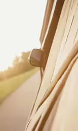 the view from inside of a vehicle looking out at a green field